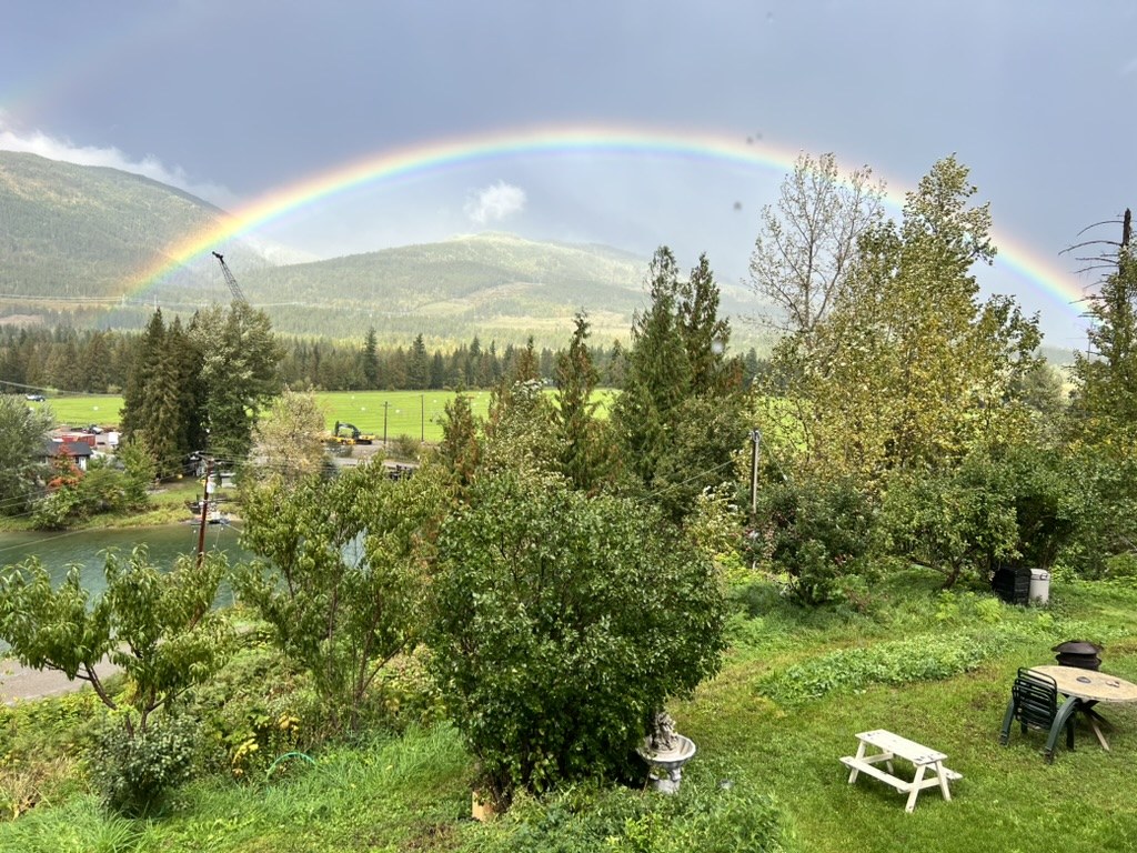Rainbow arching over the river valley